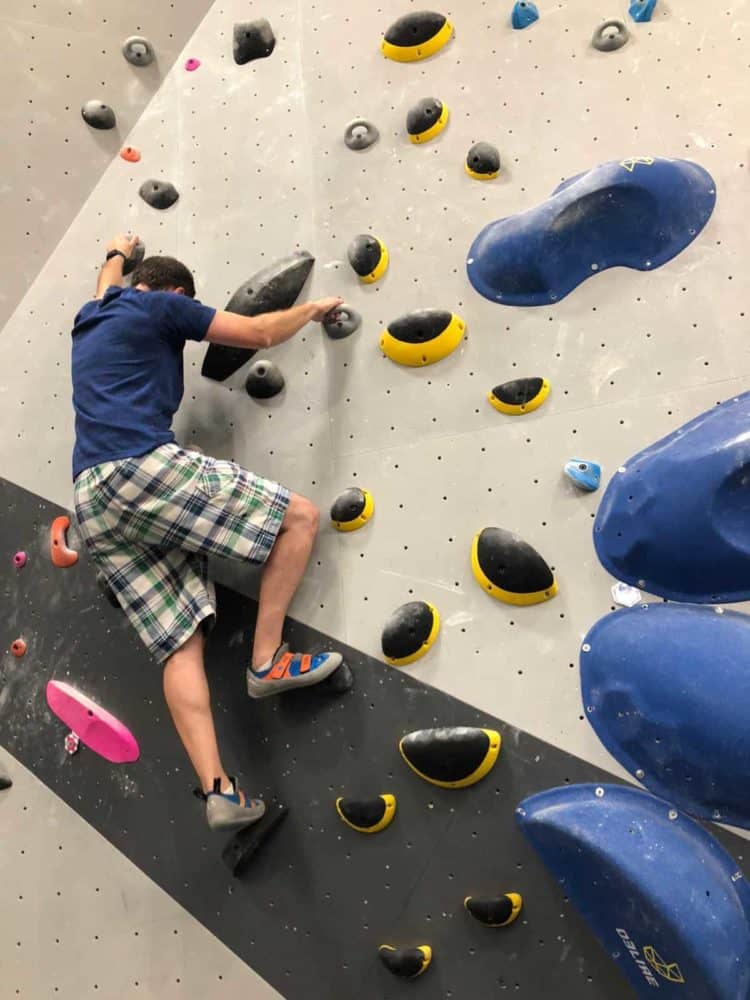 robert bouldering up a wall